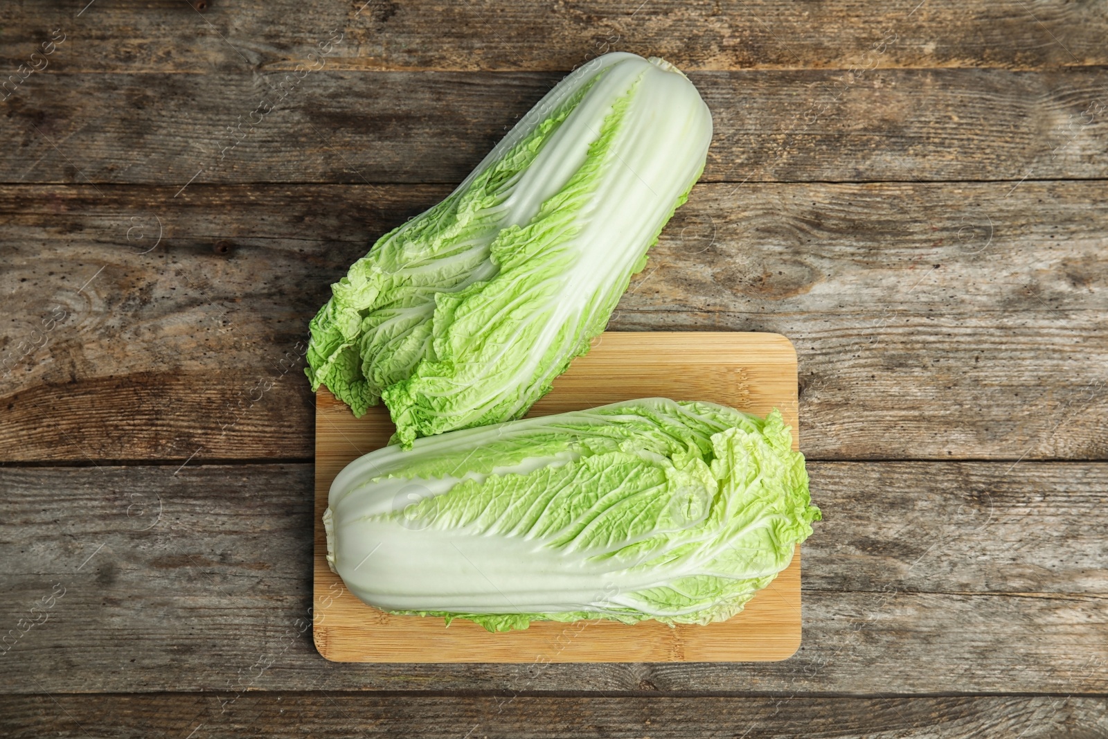 Photo of Fresh ripe cabbages on wooden table