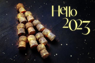Image of Hello 2023. Christmas tree made of sparkling wine corks on black background