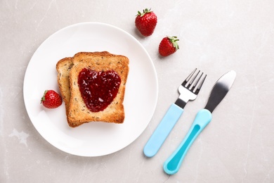Photo of Flat lay composition of toasts with jam on light grey marble table. Breakfast for kids