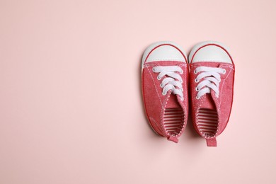 Photo of Cute baby shoes on beige background, flat lay. Space for text