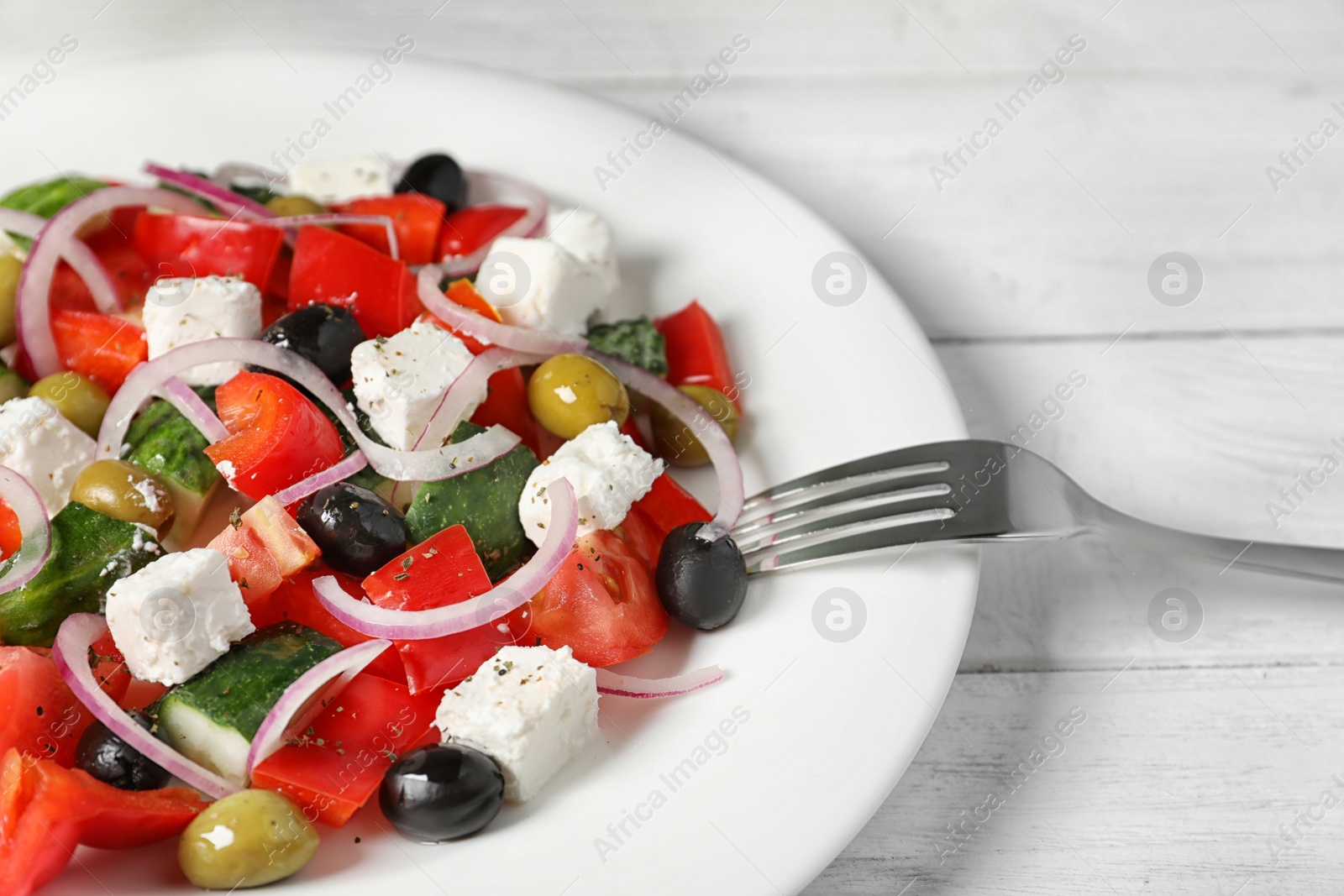 Photo of Plate with delicious salad on table, closeup