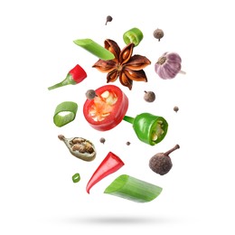 Image of Different aromatic spices falling on white background