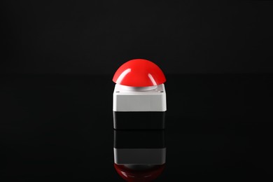 Photo of Red button of nuclear weapon on black background. War concept