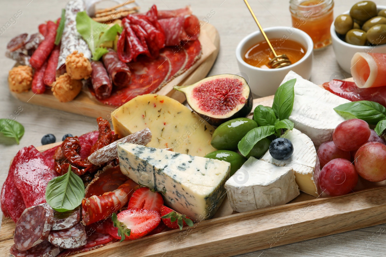 Photo of Set of different delicious appetizers served on white wooden table, closeup