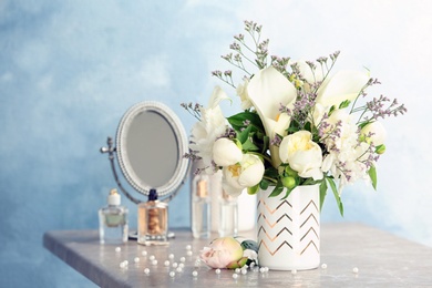 Vase with bouquet of beautiful flowers on table