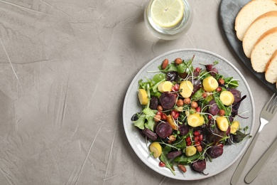 Photo of Delicious fresh carrot salad served on grey table, flat lay. Space for text