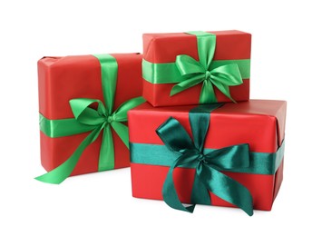 Photo of Red gift boxes with green bows on white background