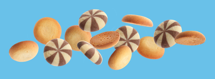 Image of Set of different falling cookies on blue background. Banner design 