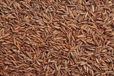 Aromatic caraway seeds as background, top view