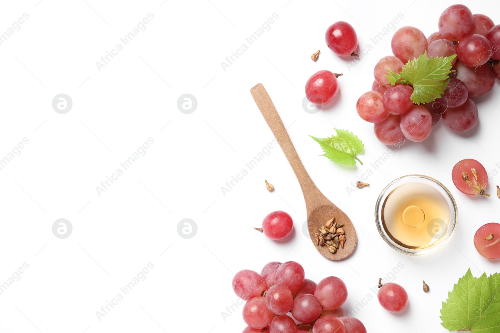 Photo of Composition with bowl of natural grape seed oil on white background, top view. Organic cosmetic