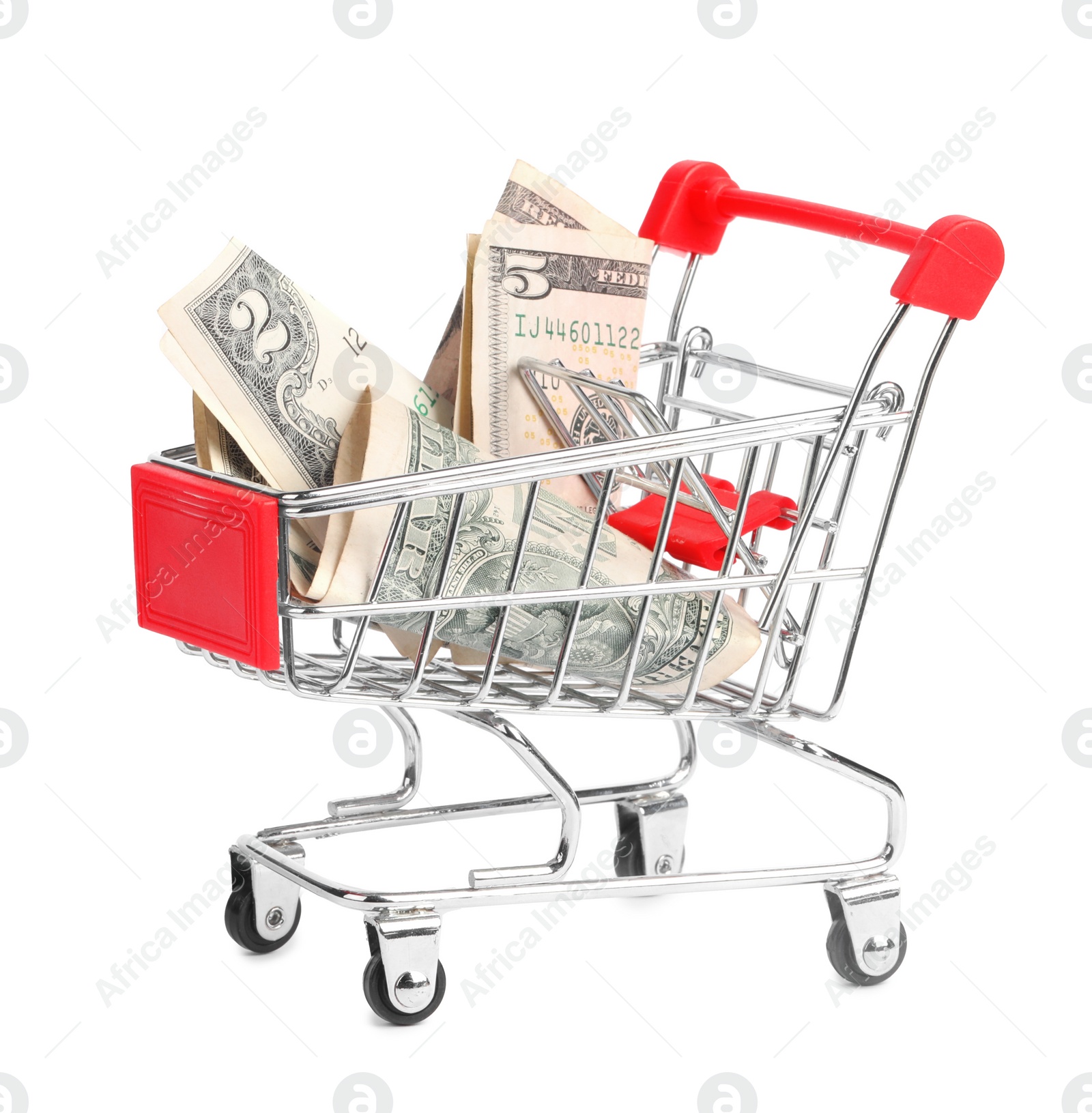 Photo of Small metal shopping cart with dollar bills isolated on white
