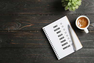 Work-life balance concept.  Flat lay composition with notebook, coffee and space for text on dark wooden background