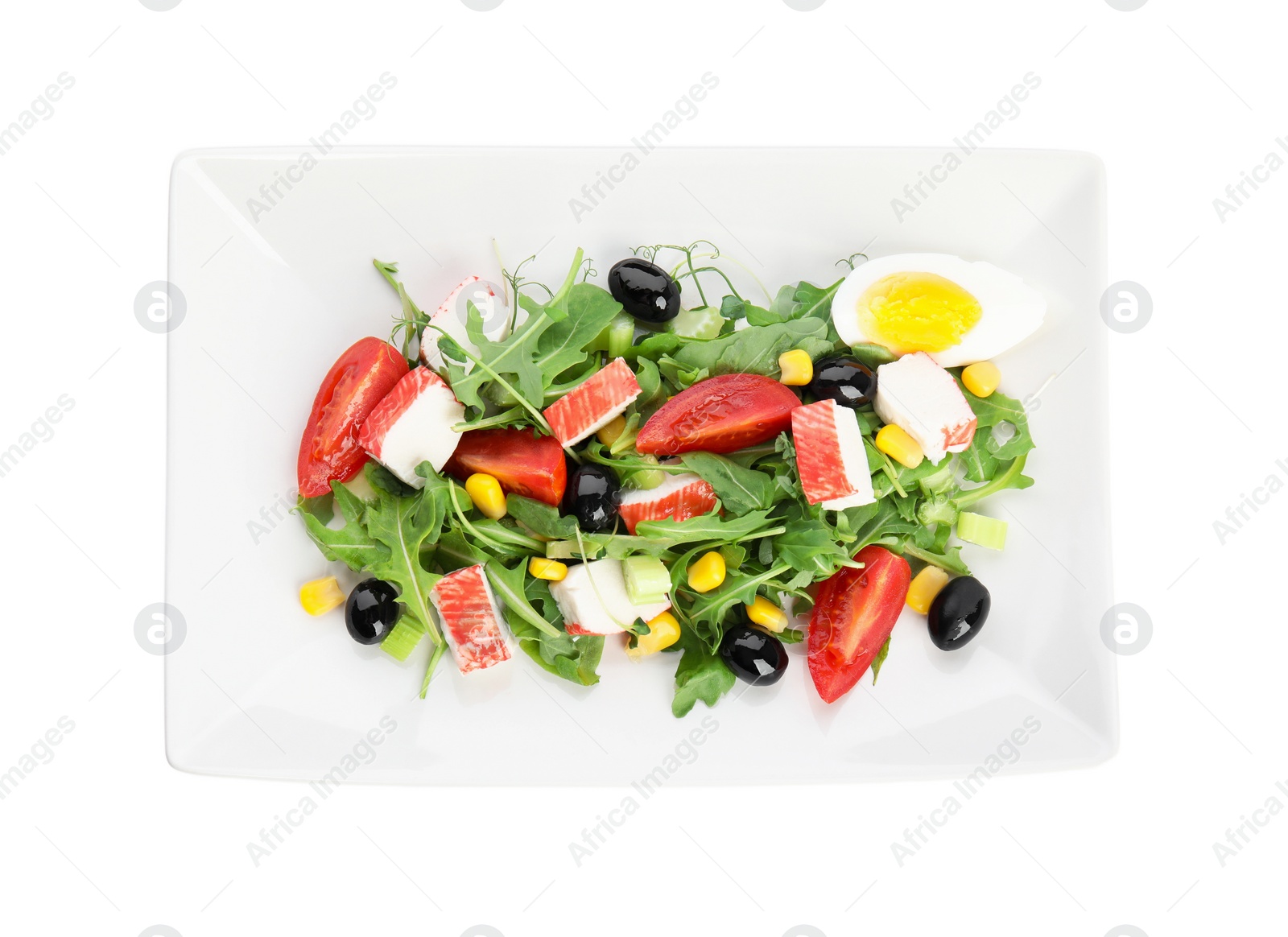 Photo of Tasty crab stick salad isolated on white, top view