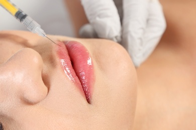 Young woman getting lips injection, closeup. Cosmetic surgery