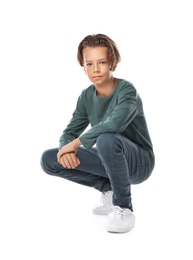 Portrait of cute little boy in casual outfit on white background