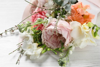 Photo of Bouquet of beautiful flowers on white wooden table, closeup