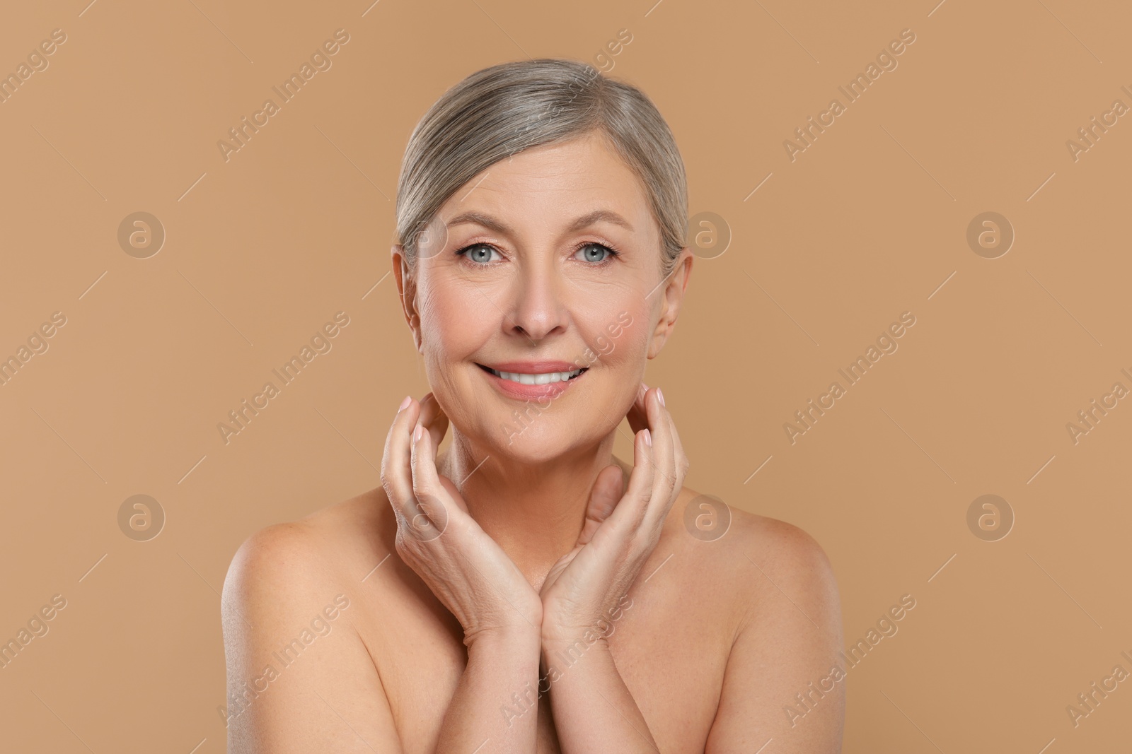 Photo of Beautiful mature woman with healthy skin on beige background