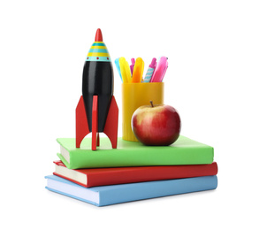 Bright toy rocket and school supplies on white background