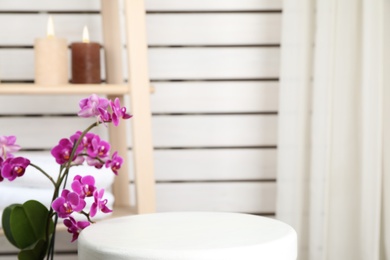 Photo of Blooming orchid and spa accessories indoors. Space for text