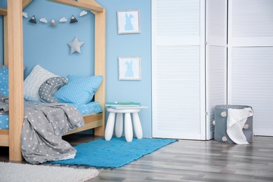 Photo of Comfortable bed in modern children room