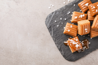 Salted caramel on light grey table, top view. Space for text