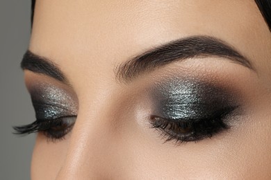 Young woman with evening makeup, closeup. Eye shadow product