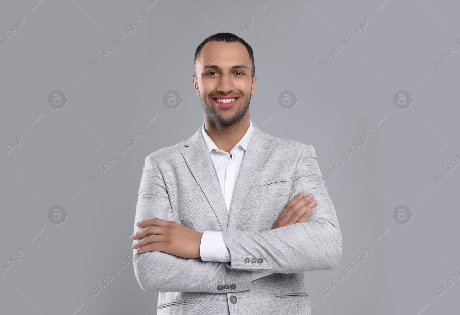 Photo of Young businessman in formal outfit on grey background