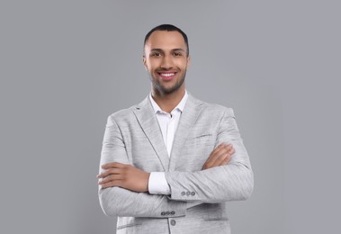 Photo of Young businessman in formal outfit on grey background