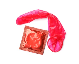 Photo of Red condoms on white background, top view. Safe sex concept