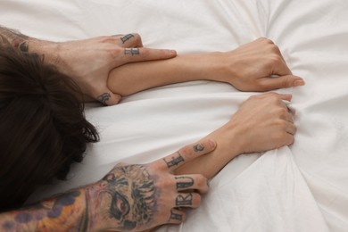 Photo of Passionate couple having sex on bed, closeup of hands