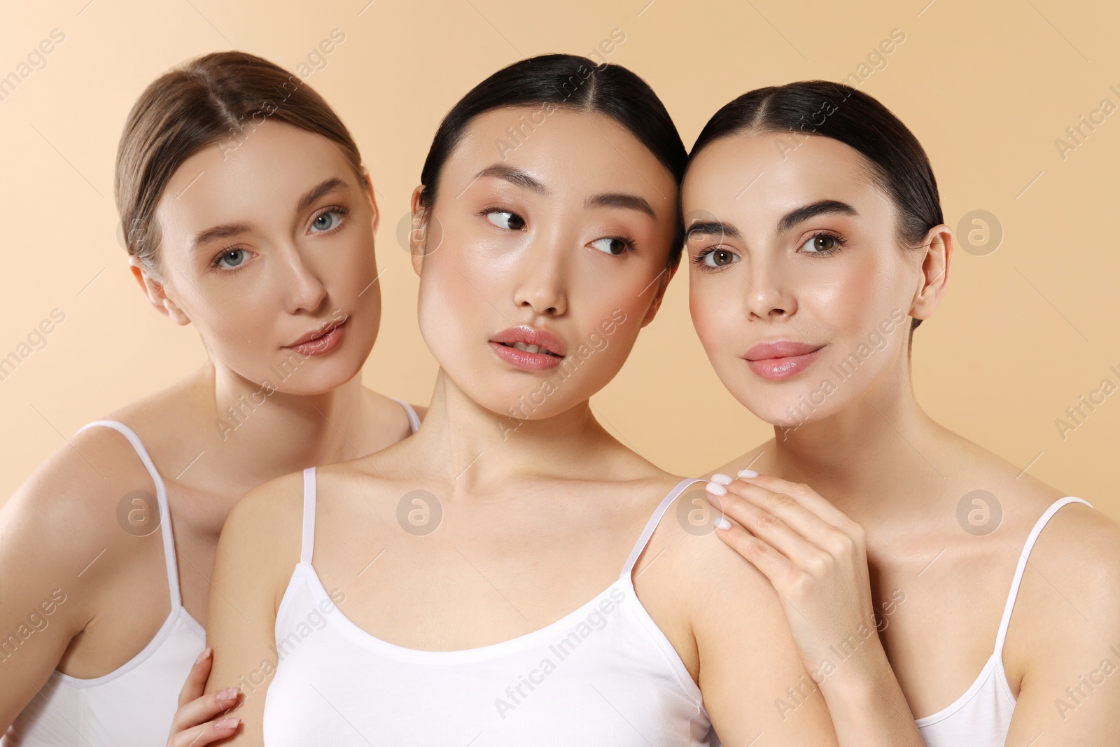 Photo of Beautiful young women with healthy skin on beige background