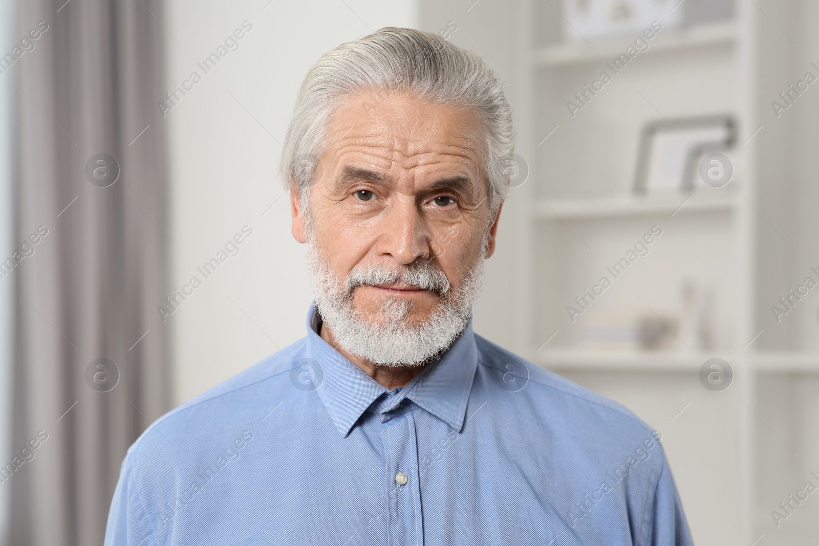 Photo of Portrait of handsome senior man at home