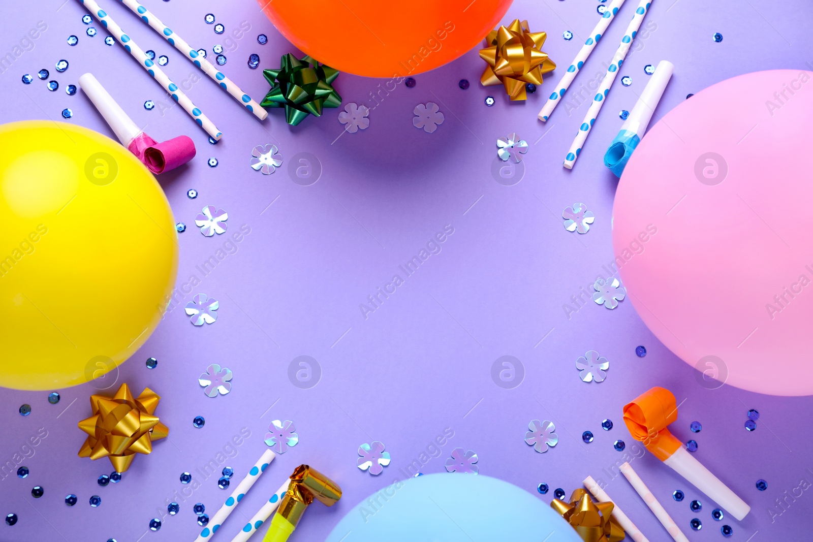 Photo of Frame of different accessories for birthday party on violet background, flat lay. Space for text