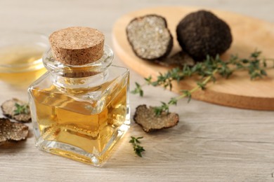 Photo of Fresh truffle oil and thyme on wooden table, closeup. Space for text