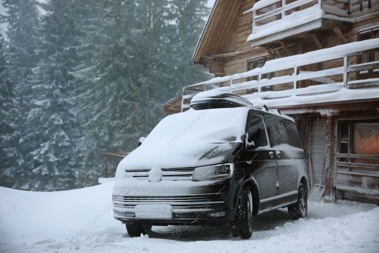 Photo of Modern car covered in snow outdoors on winter day