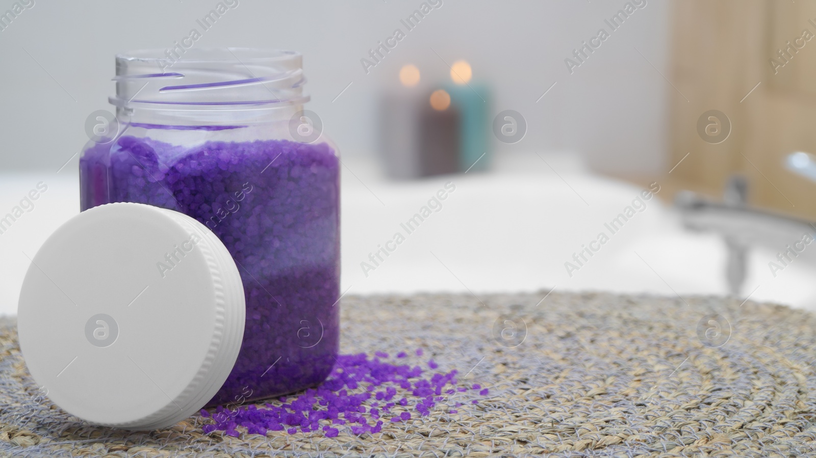 Jar with bath salt on wicker mat in bathroom. Space for text Photo of Jar with bath salt on wicker mat in bathroom. Space for text