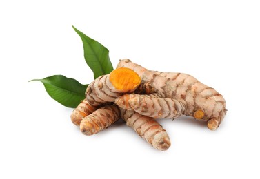 Fresh turmeric roots and green leaves isolated on white