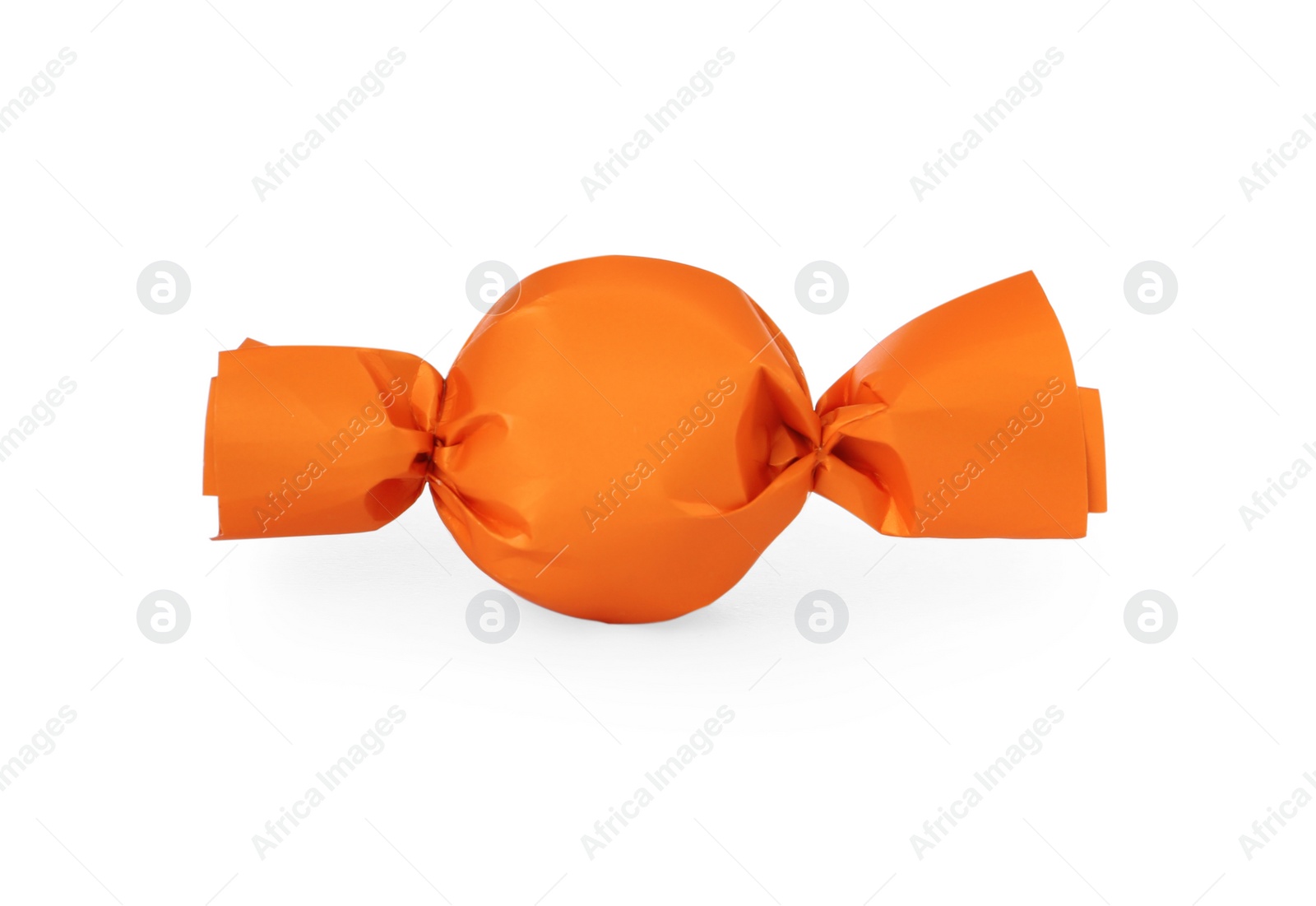 Photo of Delicious candy in orange wrapper isolated on white