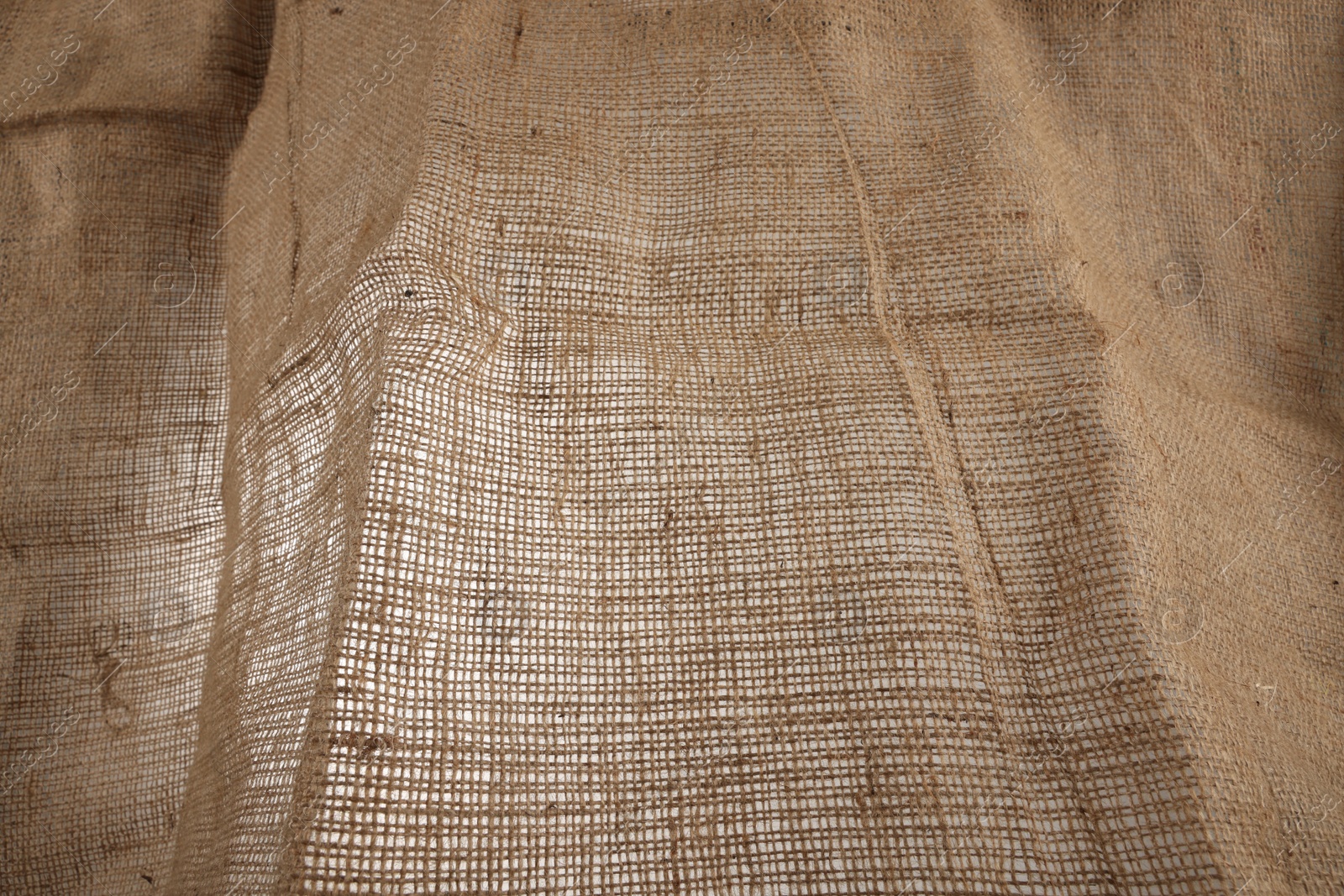 Photo of Texture of natural burlap fabric as background, closeup