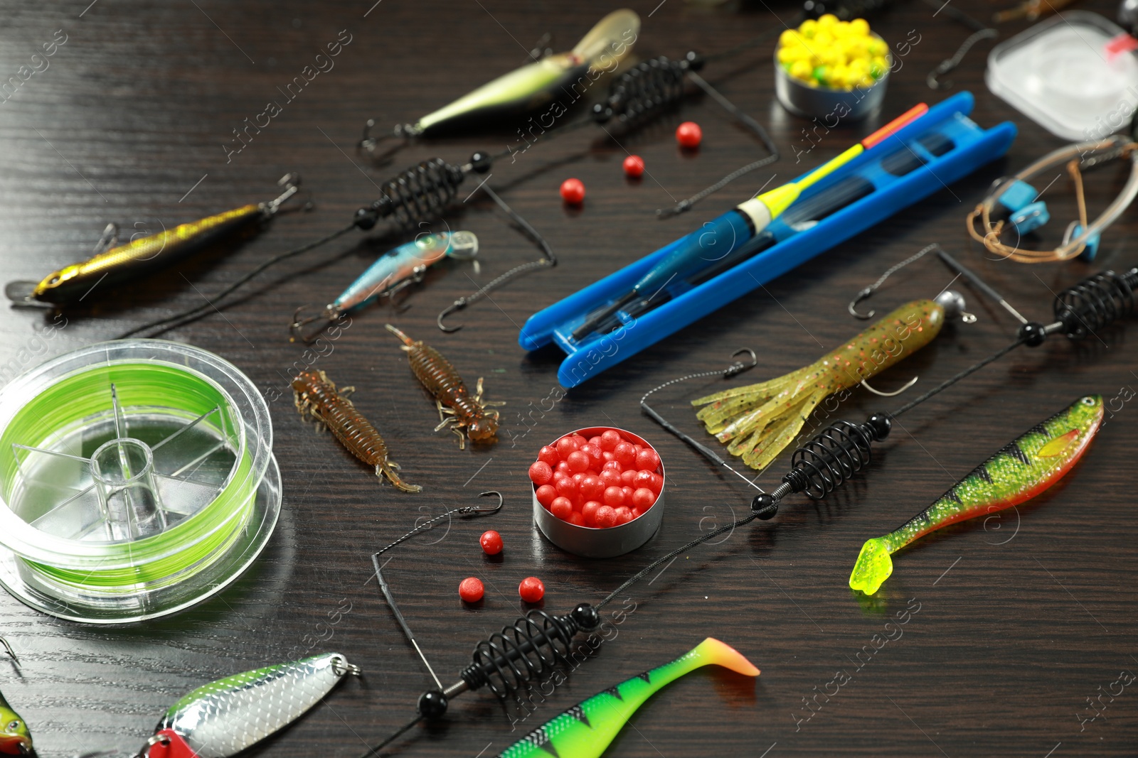 Photo of Fishing tackle on dark wooden background, closeup