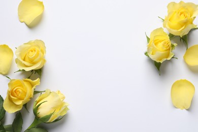 Beautiful yellow roses and petals on white background, flat lay. Space for text