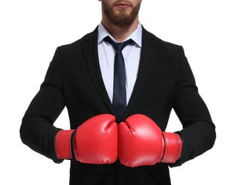 Businessman in suit wearing boxing gloves on white background, closeup