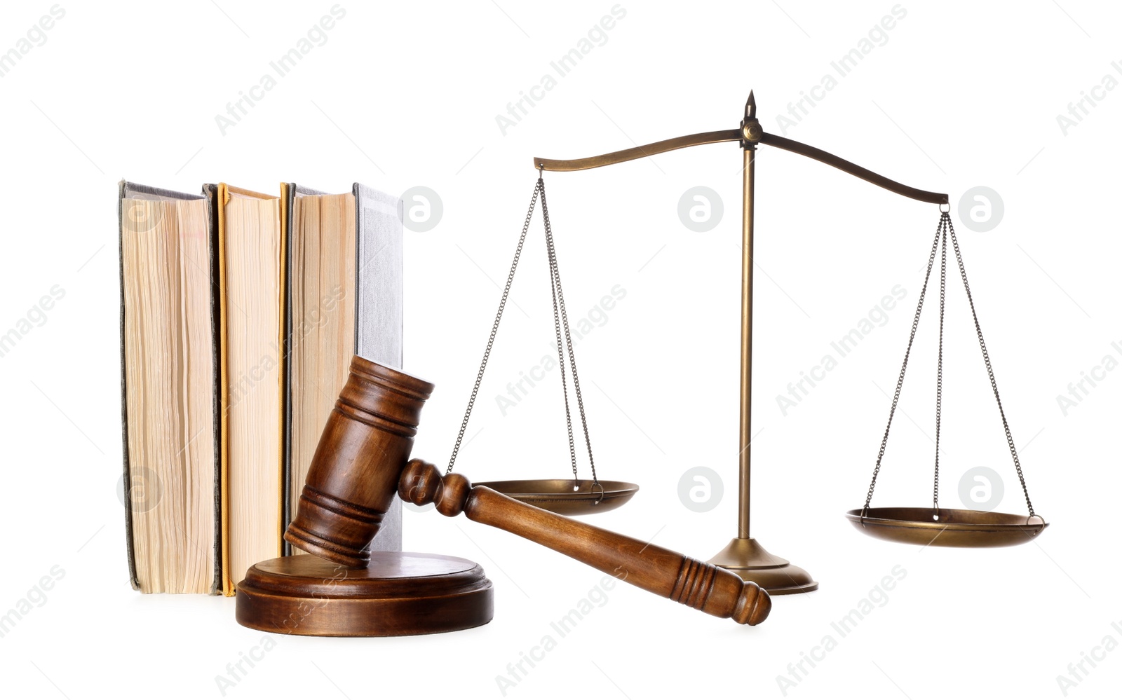 Photo of Wooden gavel, books and scales of justice on white background