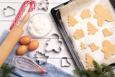 Photo of Making Christmas cookies. Flat lay composition with raw dough and ingredients on white wooden table