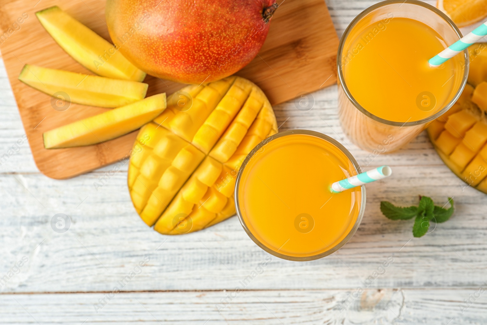 Photo of Tasty mango drink and fresh fruits on wooden table, top view