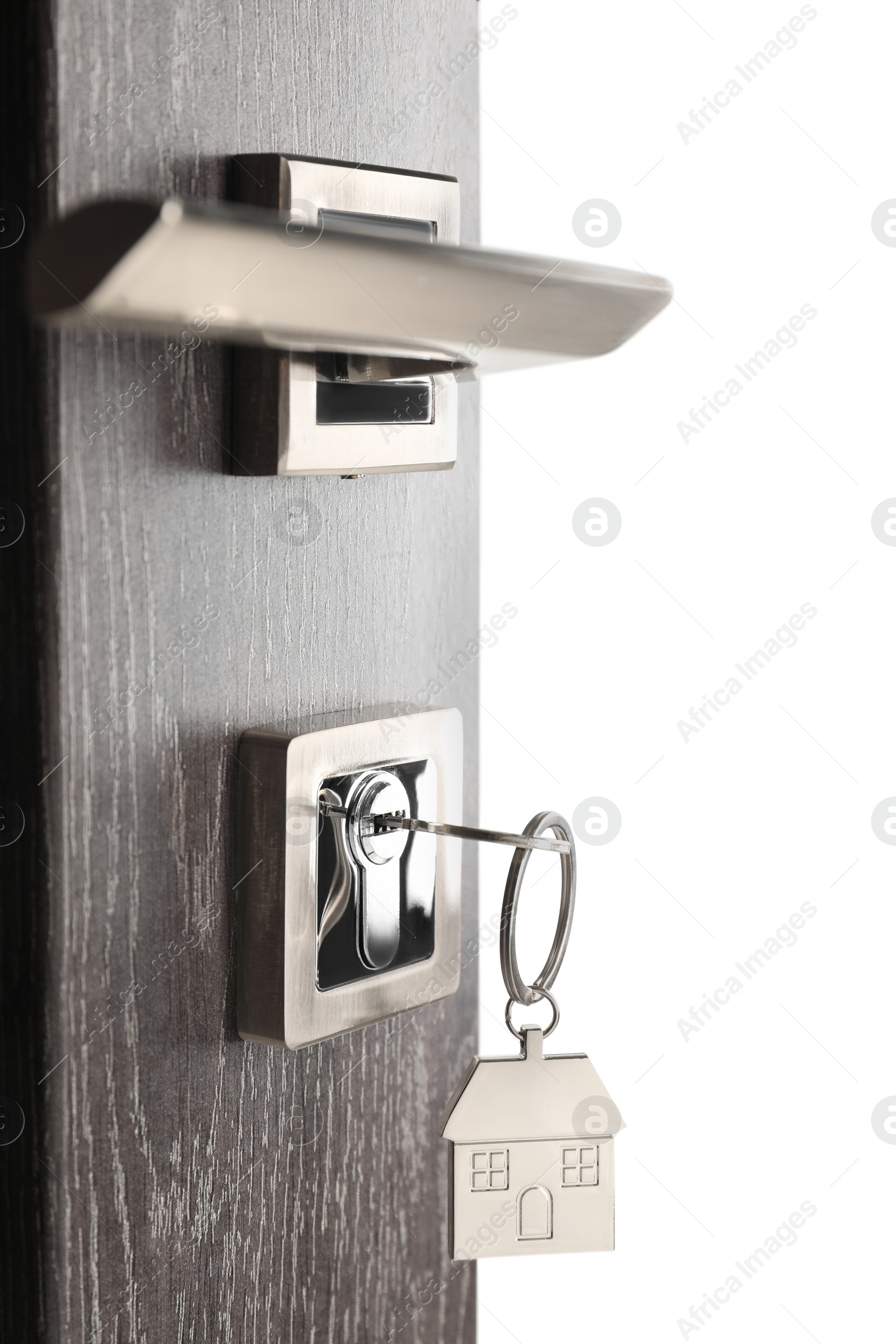 Photo of Mortgage and real estate. Open door with key and house shaped keychain on white background