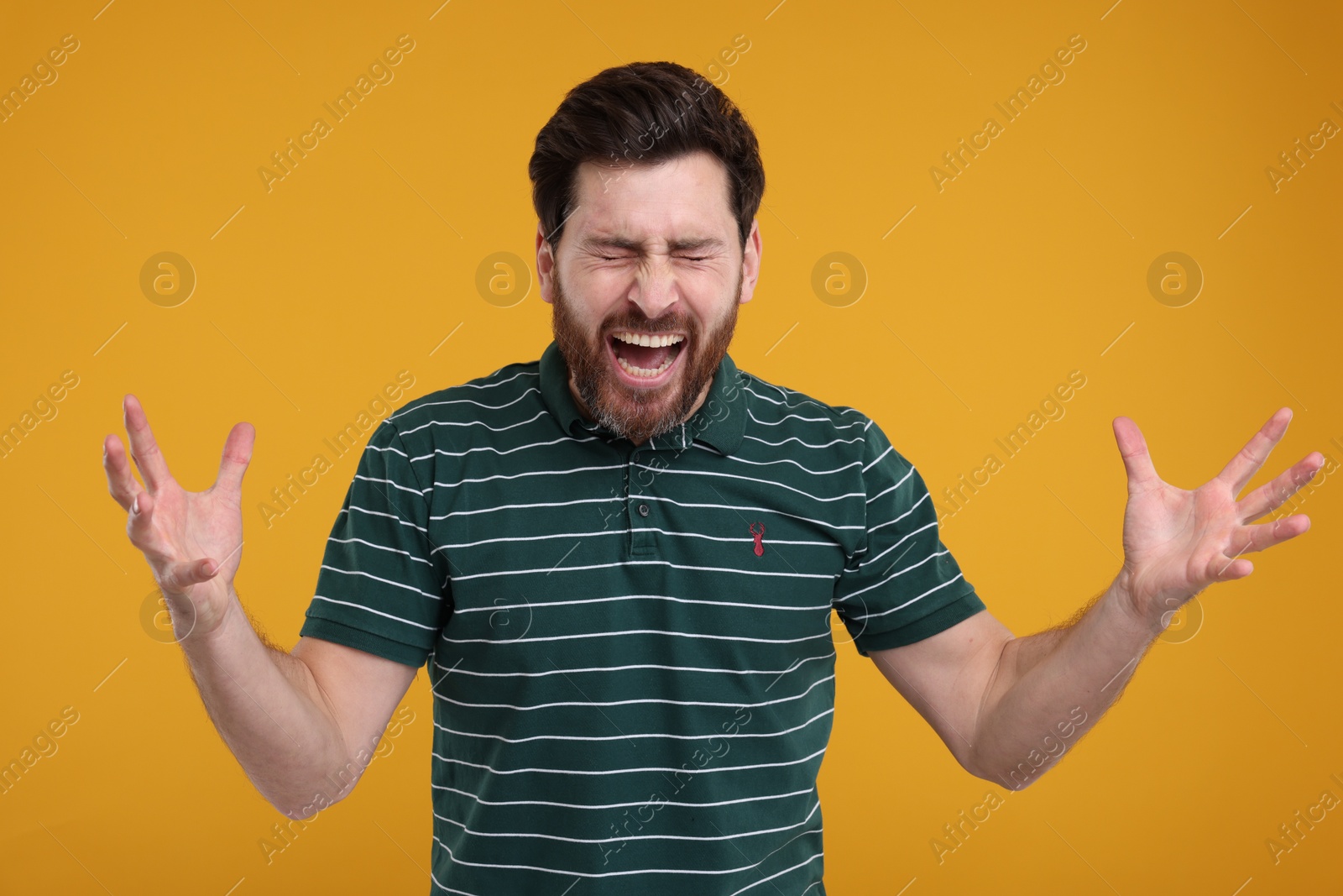 Photo of Portrait of surprised man on yellow background