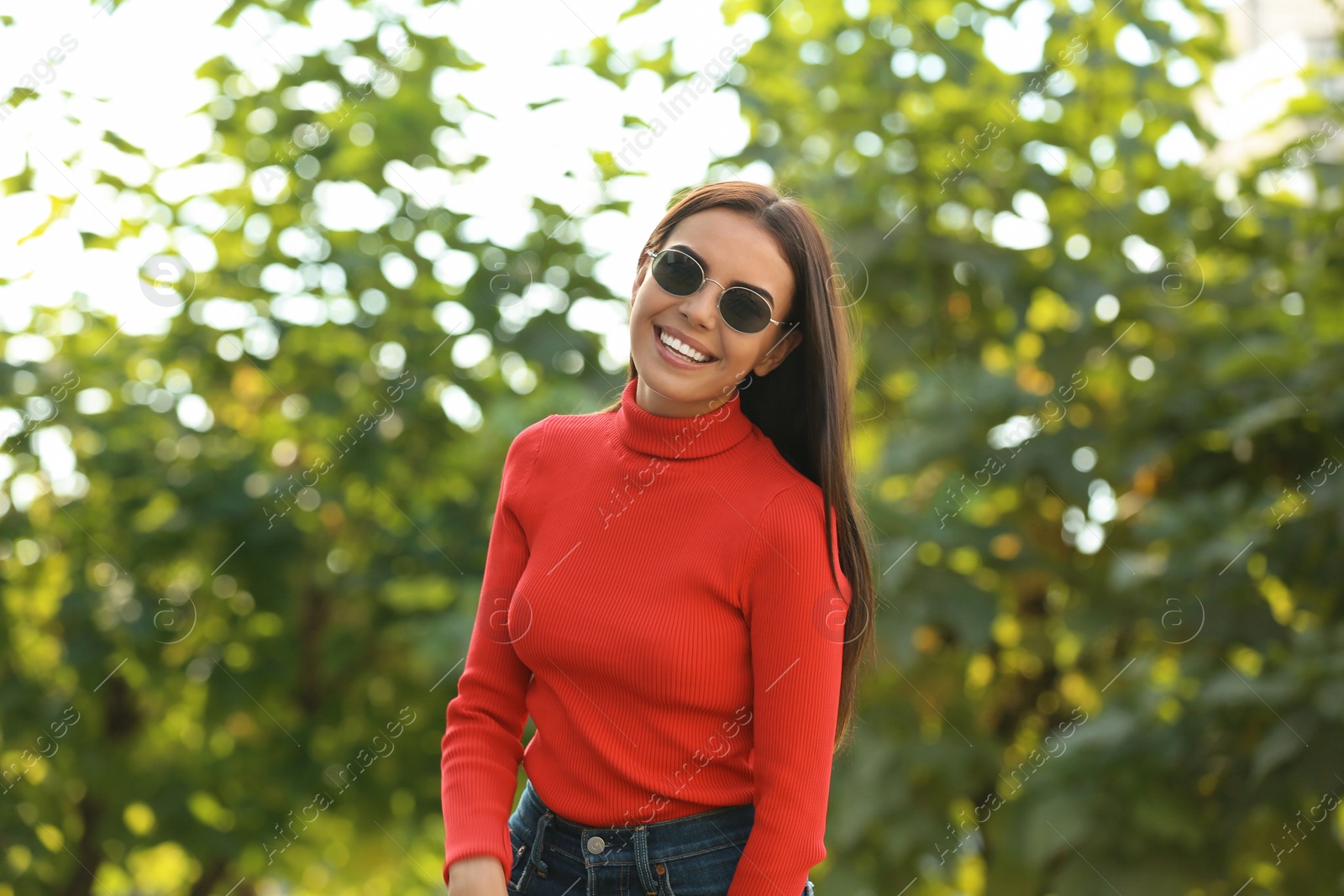 Photo of Beautiful woman wearing stylish sunglasses in green park