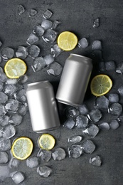 Photo of Flat lay composition with tin cans, lemon slices and ice cubes on dark background