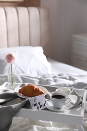 Photo of Romantic breakfast with note saying I Love You on bed